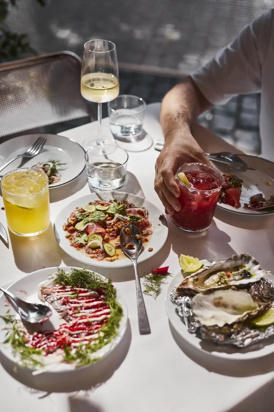 A shared table with plates in the middle at La Ñape